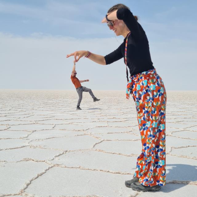 Couple playing with perspective at Salar de Uyuni in Bolivia