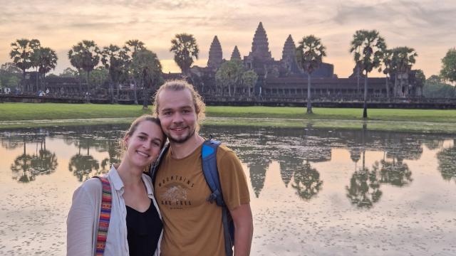 Couple taking a picture in front of the Angkor Wat in Kambodia